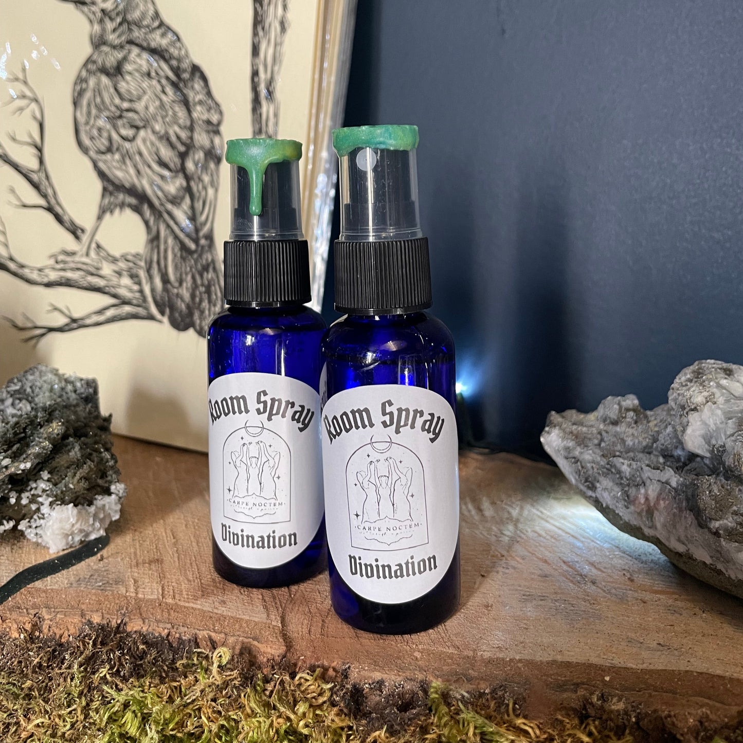 Two bottles of room spray on a stone surface with a natural background
