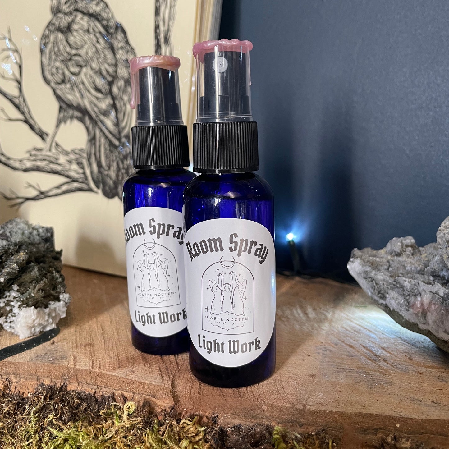 Two small bottles with sprays on a wooden surface with a natural background