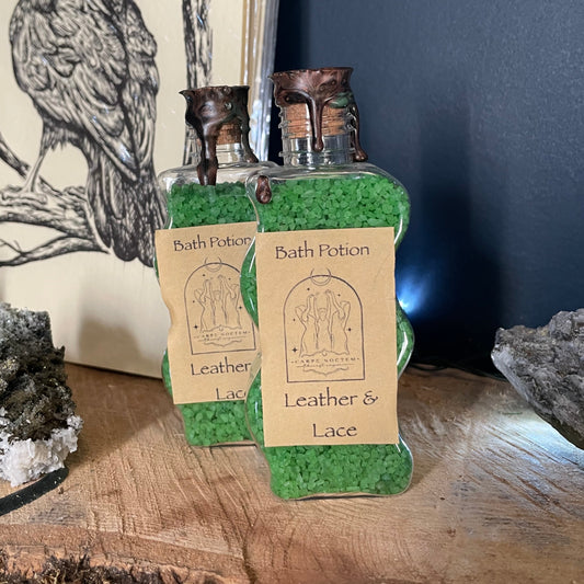 Small leather item with a label on a wooden surface and dark background