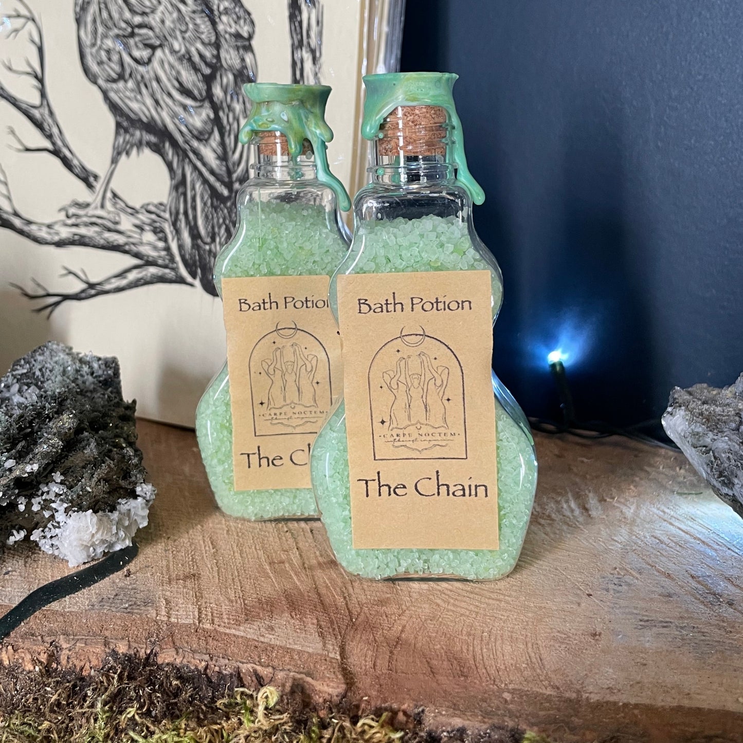 Small bottle with a label on a wooden surface with moss