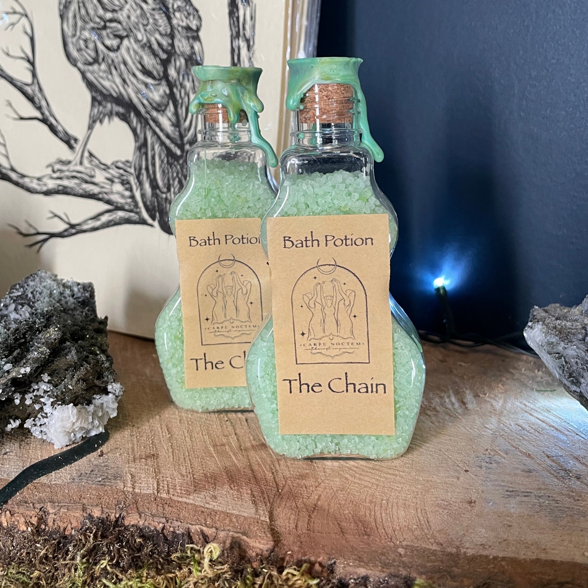 Small bottle with a label on a wooden surface with moss