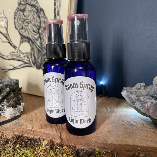 Two small bottles with sprays on a wooden surface with a natural background