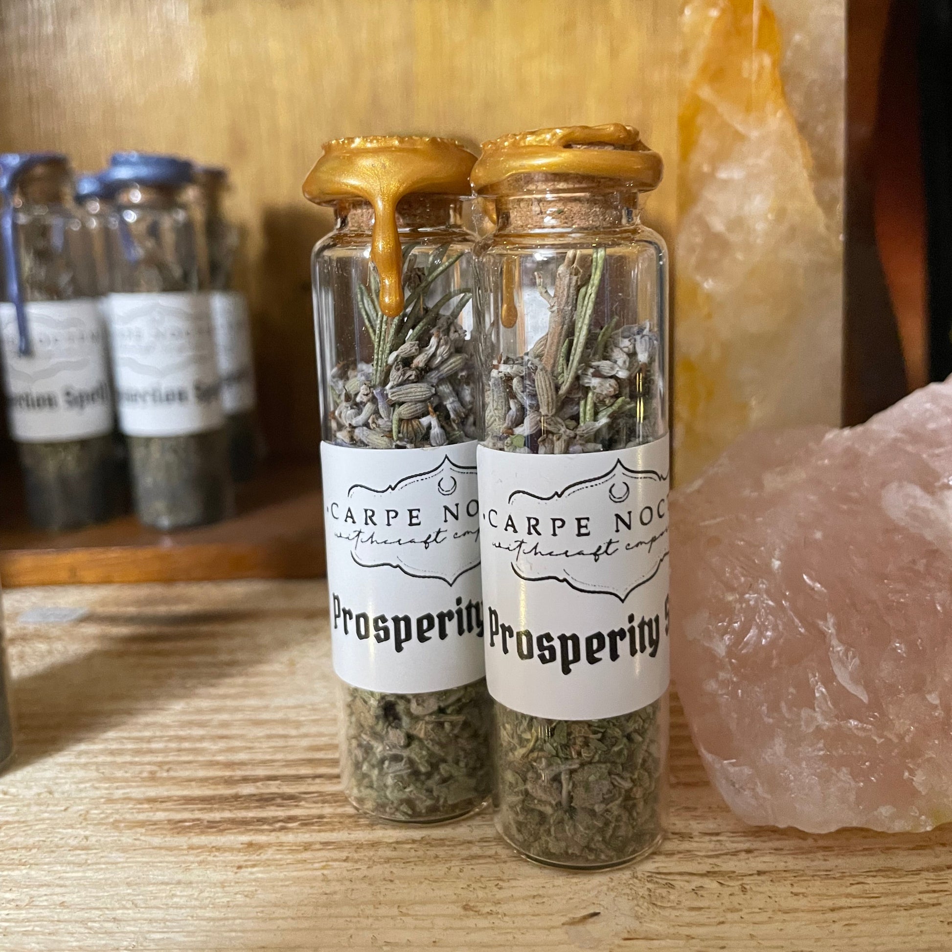 Small glass bottles with labels on a wooden surface