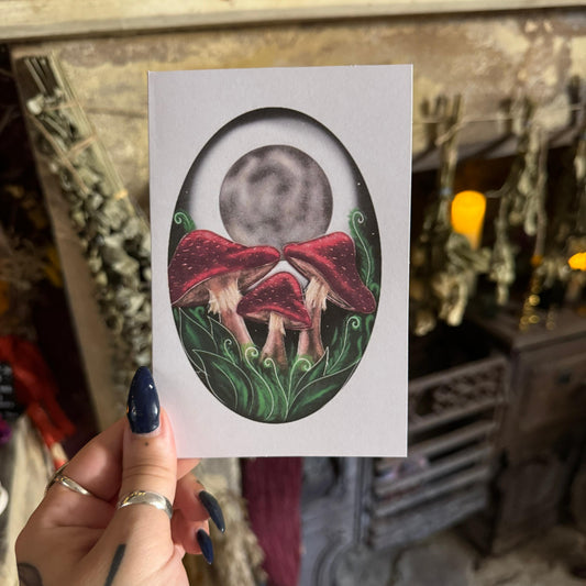 Hand holding a card with a red-bow tie design against a blurred indoor background